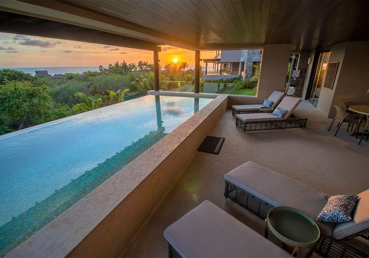 Resting area with a private pool on a beautiful sunset and seaside view