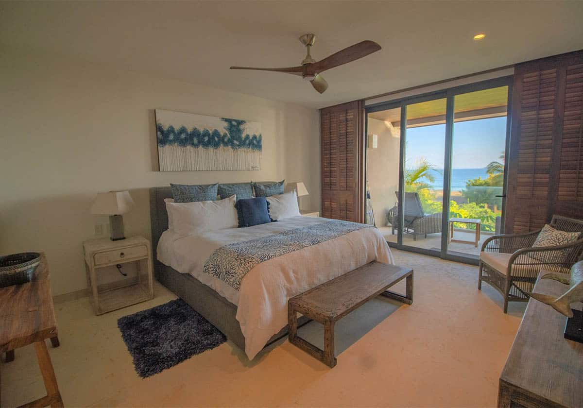 Front view of a master suite with balcony and a seaside view